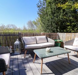 An outdoor seating area with a table and chairs at Grosvenor 10 in Llanarmon-Yn-Ial