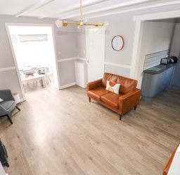 A living room with a sofa and chair at The Wool Pack in Tenby