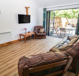 A living room with a sofa and television at Brookview Kingfisher in Haverfordwest