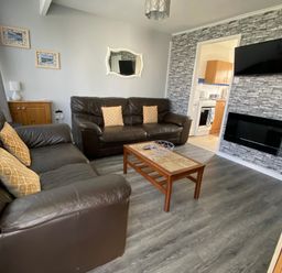 A living room with two couches and a coffee table at Chalet 57 in California, Norfolk