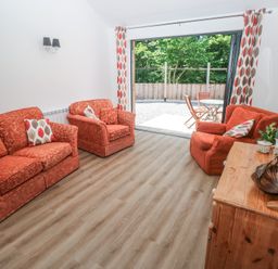 A living room with sofas and a coffee table at Brookview Goldfinch in Haverfordwest