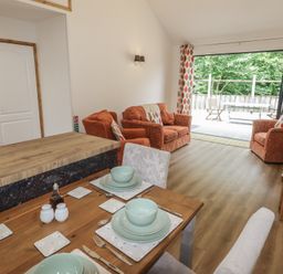 A living room with a dining table and seating area at Brookview Goldfinch in Haverfordwest