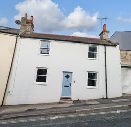 A house with a blue door and white walls at NO 10 in Fortuneswell