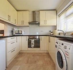 A kitchen with appliances and cabinets at Tregoning annex Lerryn near Lostwithiel
