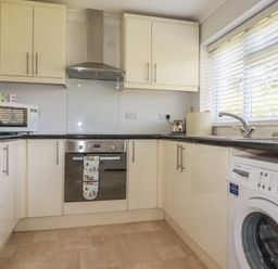 A kitchen with appliances and cabinets at Tregoning annex in Lerryn near Lostwithiel