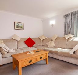 A living room with a sofa and coffee table at Tregoning in Lostwithiel