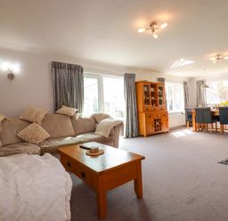 A living room with a sofa and dining table at Tregoning in Lostwithiel