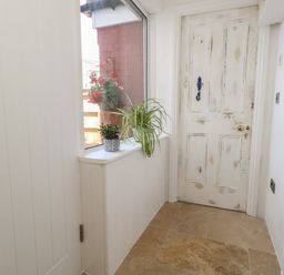 A hallway with a door and a window at Tipsy Turtle in Weymouth