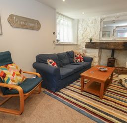 A living room with a sofa and coffee table at Tipsy Turtle in Weymouth