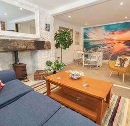 A living room with a sofa and a coffee table at Tipsy Turtle in Weymouth