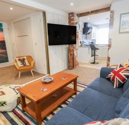 A living room with a sofa and coffee table at Tipsy Turtle in Weymouth