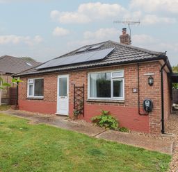 A front view of a bungalow with solar panels at 2 North Road, Maiden Newton, Dorset