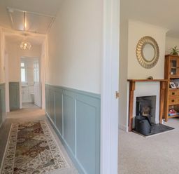A hallway with a mirror and fireplace at 2 North Road, Maiden Newton, Dorset