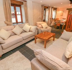A living room with sofas and a coffee table at Maerdy Cwtch in Haverfordwest