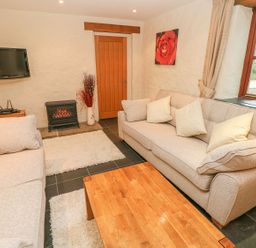 A living room with sofas and a coffee table at Maerdy Cwtch in Haverfordwest