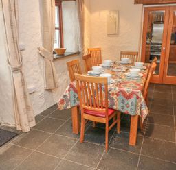 A dining room with a table set for meals at Maerdy Cwtch in Haverfordwest