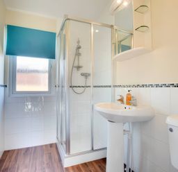 A bathroom with shower, sink, and toilet at Pet-friendly lodge with hot tub near the coast