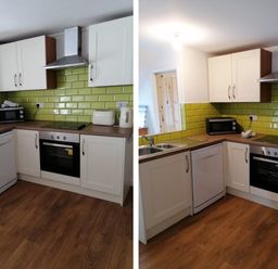 A kitchen with cabinets and appliances at Surf-ready apartment with sea views in town