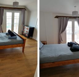 A bedroom with a bed and sliding doors at Surf-ready apartment with sea views in town
