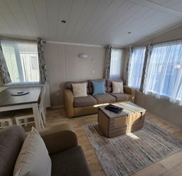 A living room with a sofa and table at Beach holiday base with pool and kids' activities