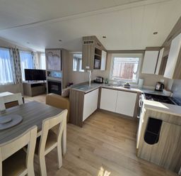 A kitchen with appliances and seating area at Beach holiday base with pool and kids' activities