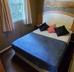 A bedroom with a bed and pillows at tbc in 