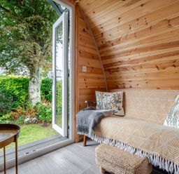 A seating area with a sofa and table at Peaceful pod with bay views, walk to 3 beaches, St Ives