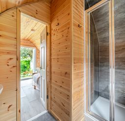 A bathroom with a shower and sink at Peaceful pod with bay views, walk to 3 beaches, St Ives
