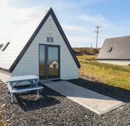 A cabin with a table in front and pathway at Cabin 9 Inish Beag, Gortahawk