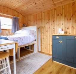 A bedroom with a bed and kitchen unit at Hazel