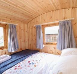 A bedroom with a bed and windows at Hazel in