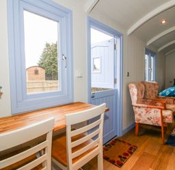 A living room with a table and chairs at Skye in Clee Hill
