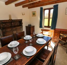 A dining room with a table set for dinner at Park Hall Cottage in Solva