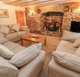 A living room with sofas and a fireplace at Maerdy Lodge 