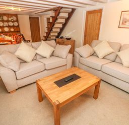 A living room with sofas and a coffee table at Maerdy Lodge