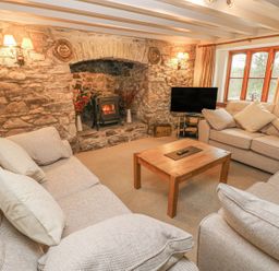 A living room with a sofa and a coffee table at Maerdy Lodge
