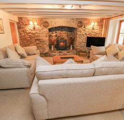 A living room with sofa and fireplace at Maerdy Lodge