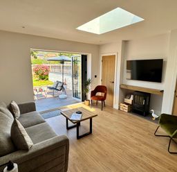A living room with seating and a coffee table at Y Bwthyn in Pembrey