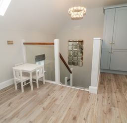 A landing with a table and chairs at 2 Ard an Chuain Dunfanaghy