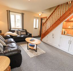 A living room with sofa and coffee table at 4 Mellbecks Mews Kirkby Stephen