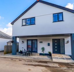 A house with front door and seating area at Meadow Retreat in Bodmin