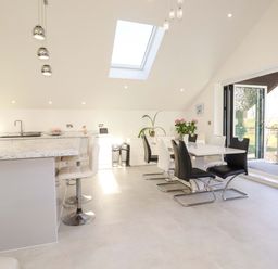 A kitchen with a dining table and sliding door at Meadow Retreat in Bodmin