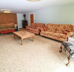 A living room with multiple sofas and a coffee table at Hazeldene near Harvington