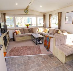 A living room with a sofa and coffee table at Sunflower Retreat, Caravan 61