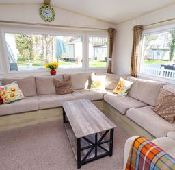 A living room with a sofa and coffee table at Sunflower Retreat, Caravan 61