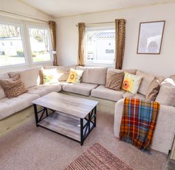 A living room with a sofa and coffee table at Sunflower Retreat, Caravan 61
