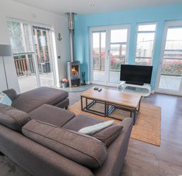 A living room with a fireplace and television at Warleggan in Redruth