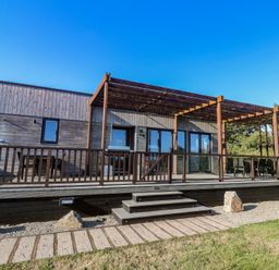 An outdoor area with a deck and pergola at Warleggan in Portreath