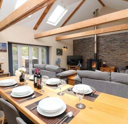 A dining area and living room in Cider Press Cottage Torpoint