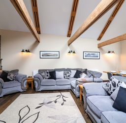 A living room with sofas and a coffee table at Cider Press Cottage in Torpoint